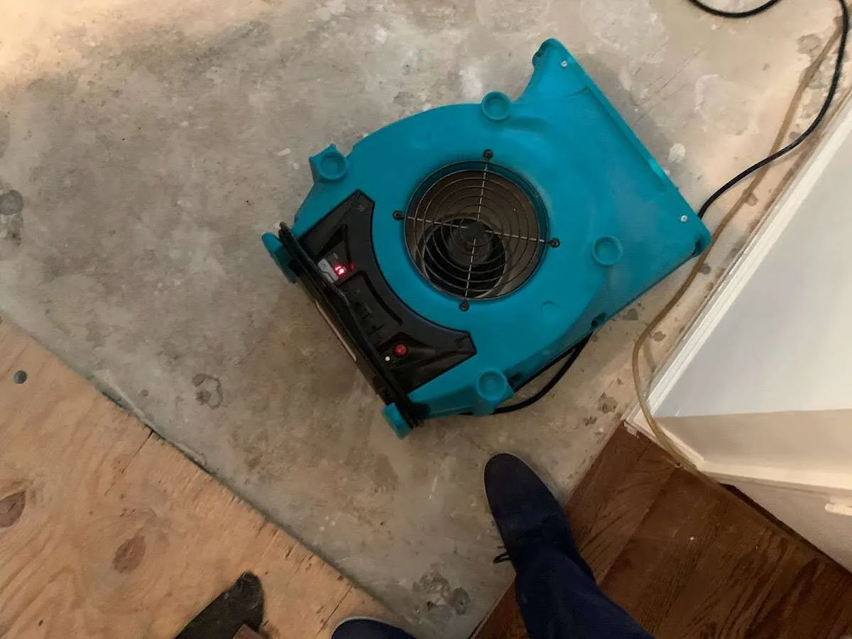Air mover drying subfloor during Commercial Water Damage Restoration in Elk Ridge